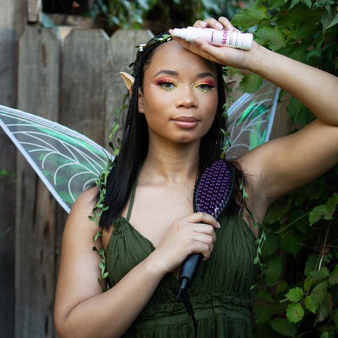 Earth Fairy holding STRAIGHT UP MAX and GLOSS Hair Oil